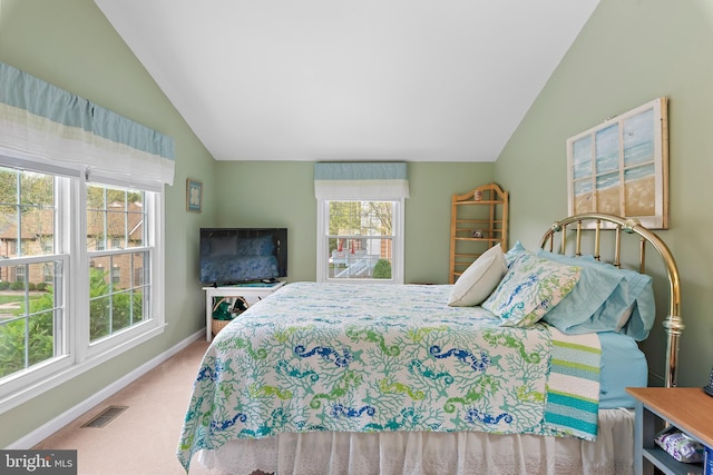 carpeted bedroom with lofted ceiling