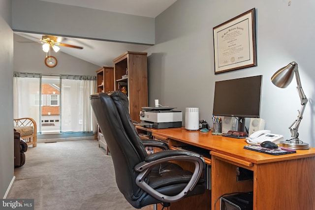 home office with lofted ceiling, light colored carpet, and ceiling fan