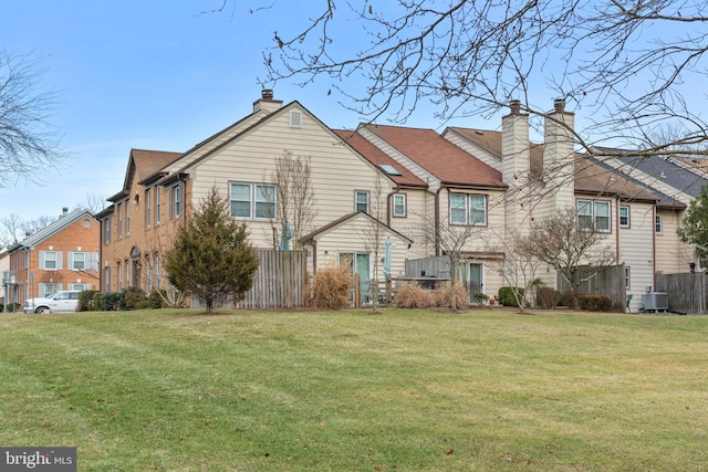 back of house with a yard and cooling unit