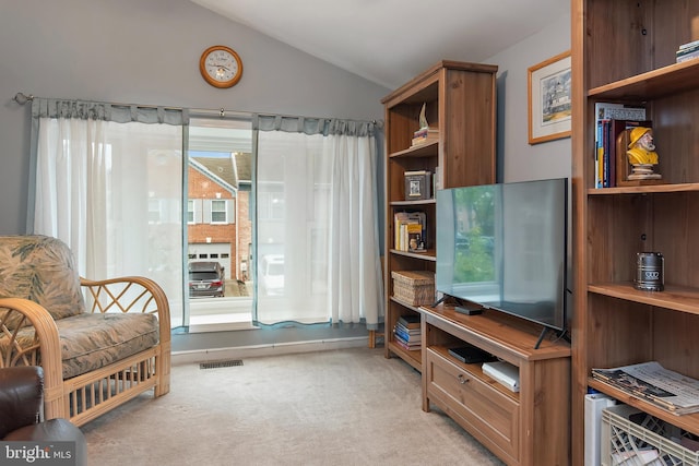 living area featuring light carpet and lofted ceiling