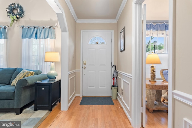 entryway featuring crown molding and hardwood / wood-style floors