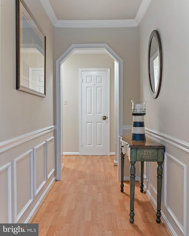 corridor with crown molding and light hardwood / wood-style flooring