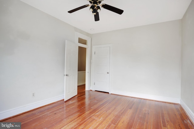 empty room featuring ceiling fan and hardwood / wood-style flooring