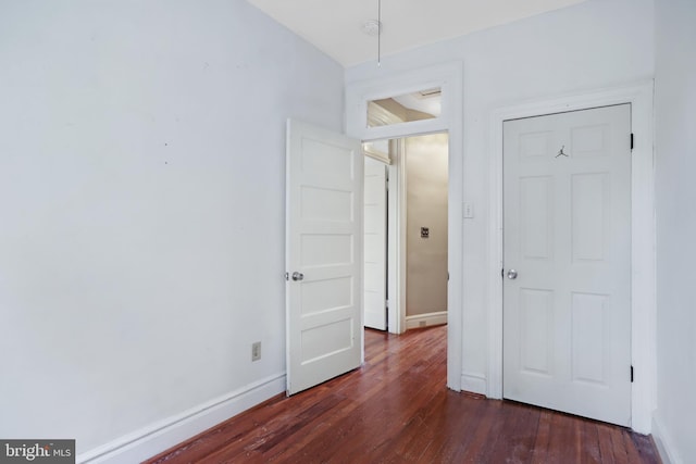 unfurnished bedroom with dark hardwood / wood-style floors