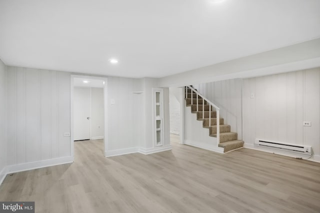 basement with a baseboard radiator and light wood-type flooring