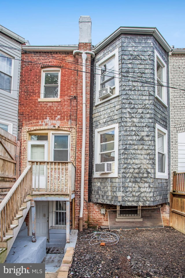 rear view of house featuring cooling unit