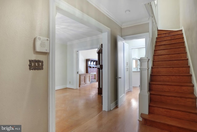 interior space with ornamental molding and light hardwood / wood-style flooring