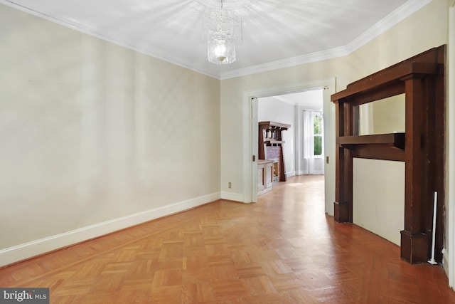 empty room featuring crown molding, parquet flooring, and a chandelier