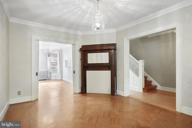 empty room with an inviting chandelier, crown molding, radiator heating unit, and light parquet flooring