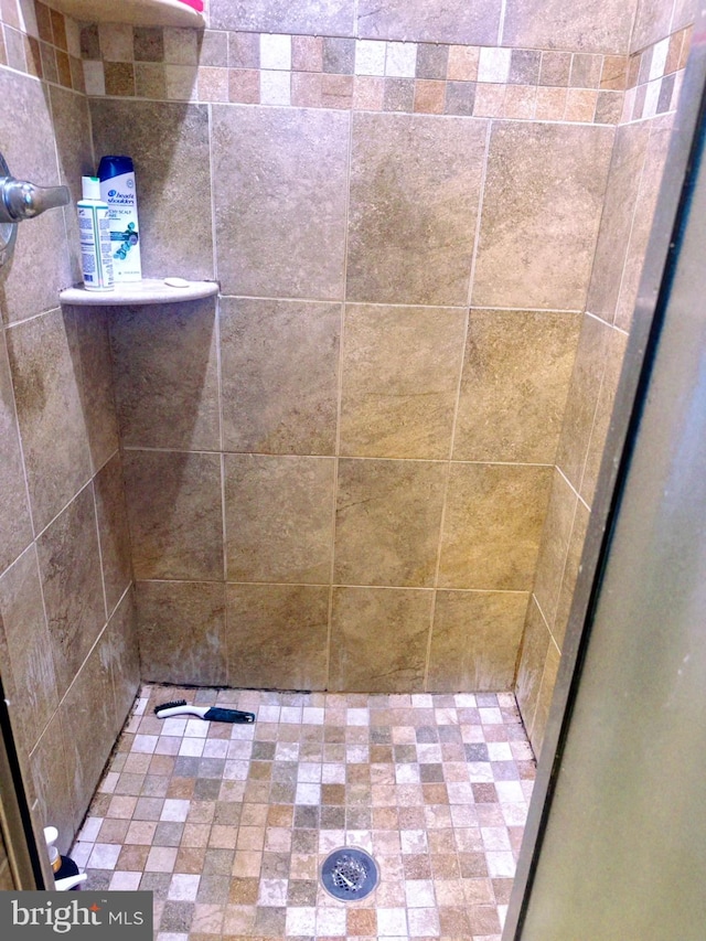 bathroom with tiled shower