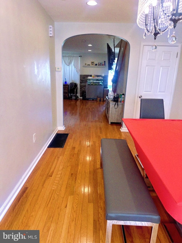 interior space with wood-type flooring and a chandelier