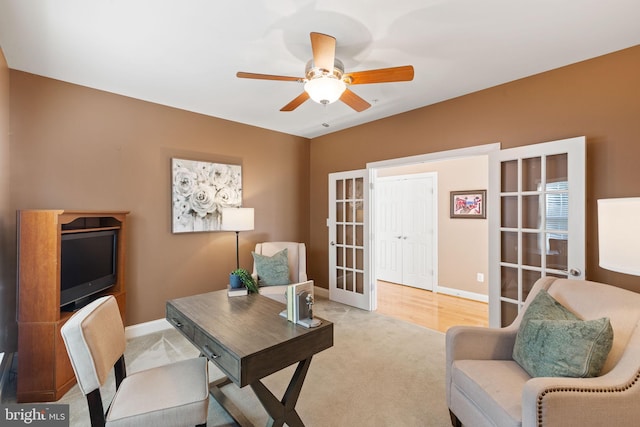 carpeted office featuring ceiling fan and french doors