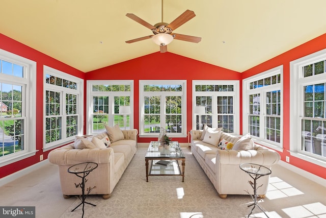 carpeted living room featuring ceiling fan, lofted ceiling, and plenty of natural light