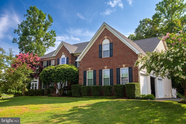 view of front of home with a front yard and a garage