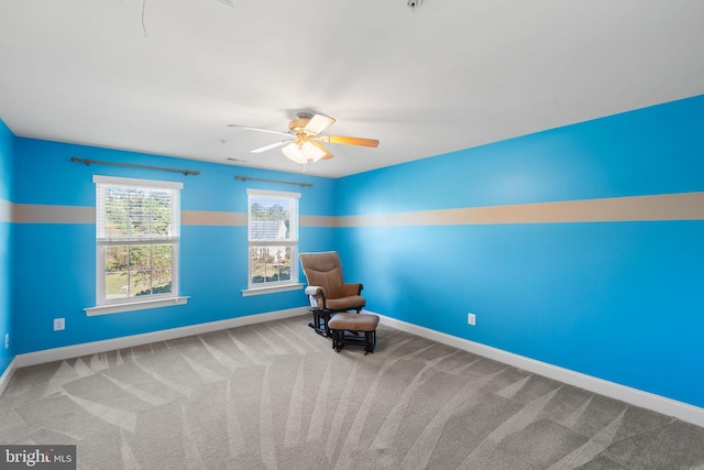 unfurnished room featuring ceiling fan and carpet