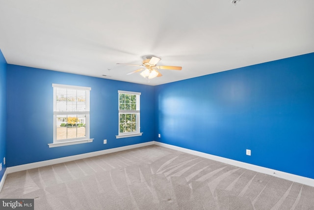 unfurnished room with ceiling fan and carpet flooring