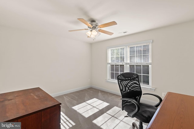 carpeted office with ceiling fan