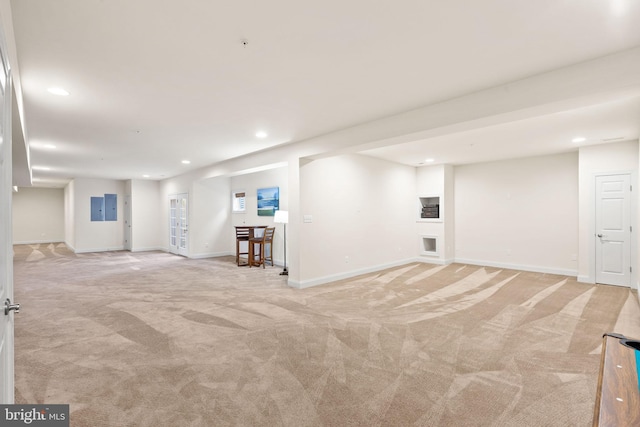 basement with light carpet and electric panel