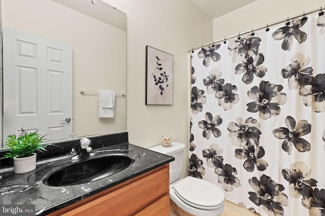 bathroom with vanity, toilet, and curtained shower