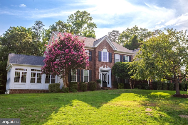 colonial inspired home with a front yard