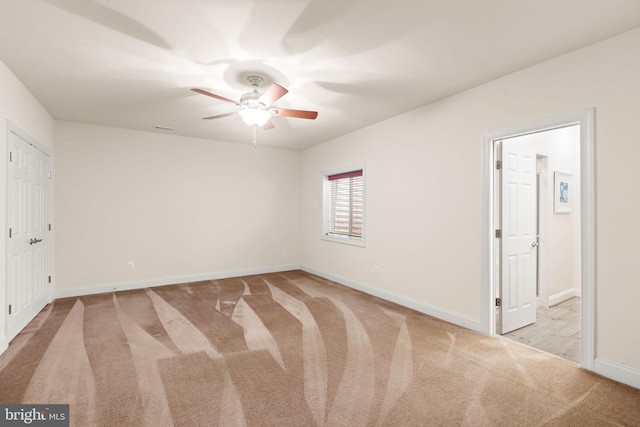 unfurnished bedroom featuring light colored carpet and ceiling fan