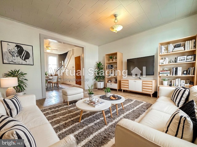 living room with ceiling fan and hardwood / wood-style floors