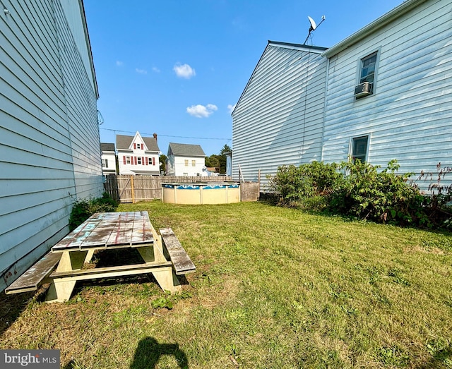 view of yard with a fenced in pool