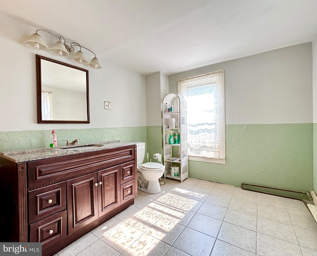 bathroom with tile patterned flooring, vanity, and toilet