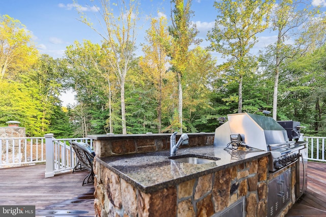 wooden terrace with area for grilling and sink