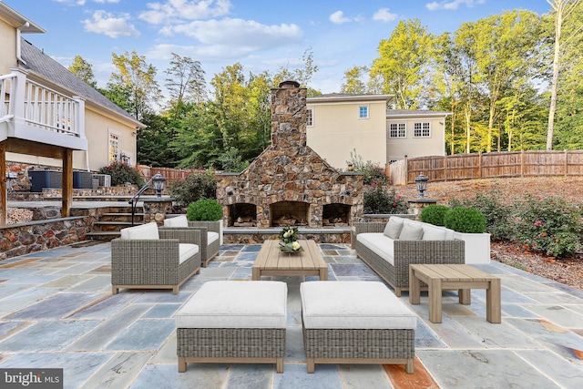 view of patio featuring an outdoor living space with a fireplace