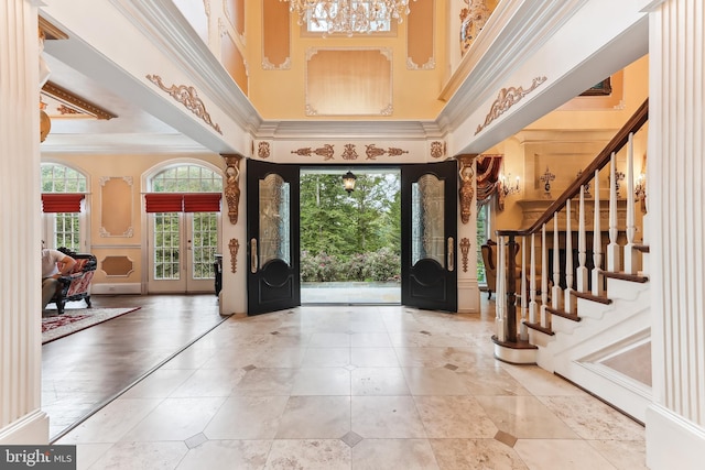 entryway with a high ceiling, a chandelier, and a wealth of natural light