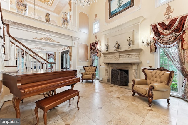 misc room featuring a towering ceiling and crown molding