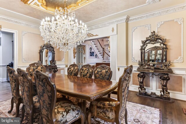 dining area with a textured ceiling, crown molding, dark wood-type flooring, and a notable chandelier