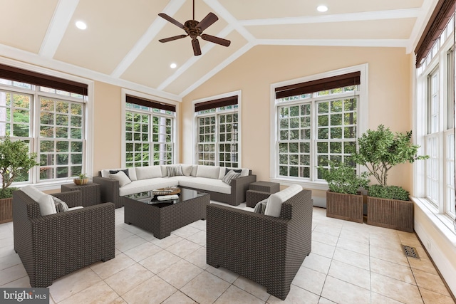 sunroom with ceiling fan and vaulted ceiling with beams