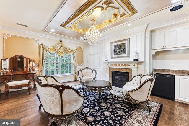 living room with crown molding, dark hardwood / wood-style floors, and a chandelier