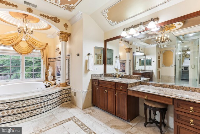 bathroom with vanity, shower with separate bathtub, decorative columns, ornamental molding, and a notable chandelier