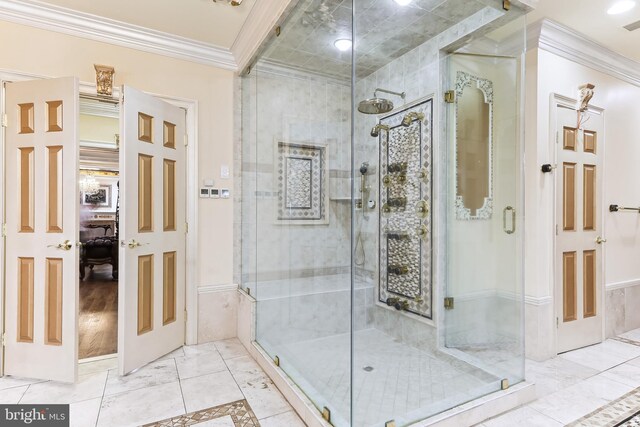 bathroom featuring crown molding and a shower with door