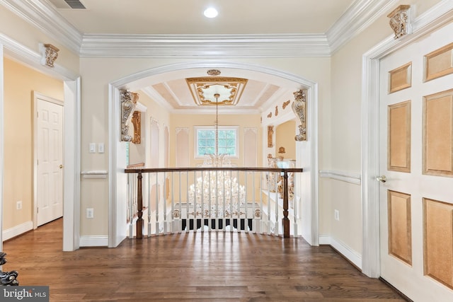 hallway featuring a notable chandelier, ornamental molding, and dark hardwood / wood-style flooring