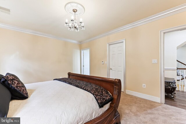 bedroom with ornamental molding, a notable chandelier, and carpet floors