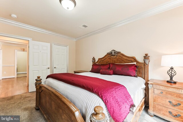 bedroom with carpet and crown molding