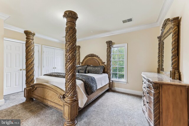 bedroom featuring ornamental molding, a closet, and carpet flooring