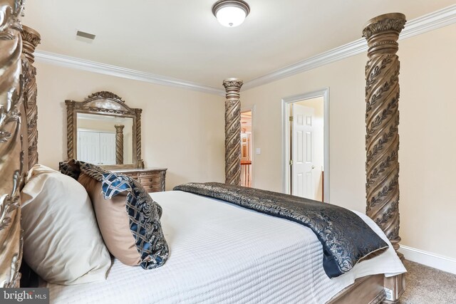 bedroom with ornamental molding and carpet flooring