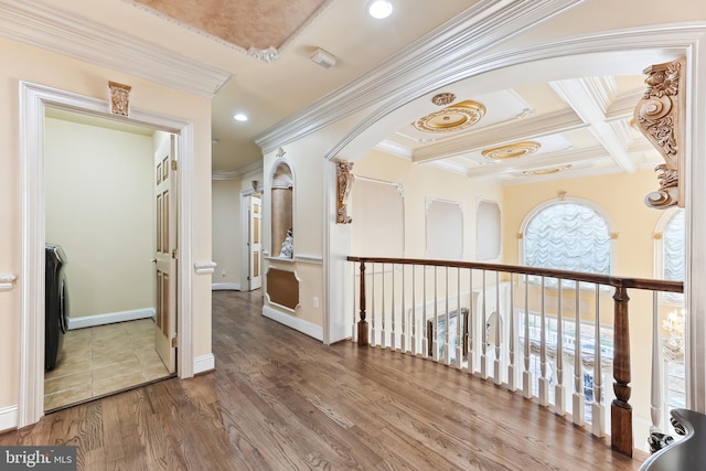 corridor with ornamental molding, coffered ceiling, hardwood / wood-style floors, and beamed ceiling