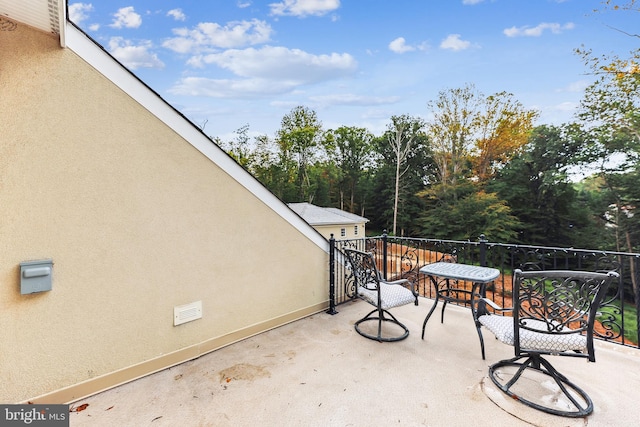 view of patio featuring a balcony