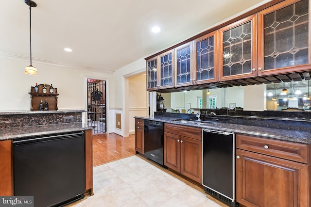 kitchen with hanging light fixtures, ornamental molding, sink, black dishwasher, and light wood-type flooring