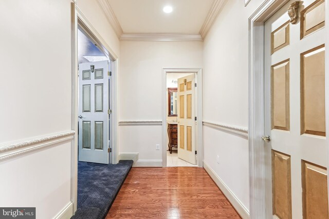 hallway featuring light hardwood / wood-style flooring and ornamental molding