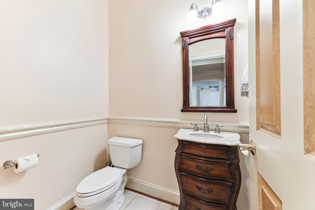 bathroom featuring tile patterned flooring, vanity, and toilet