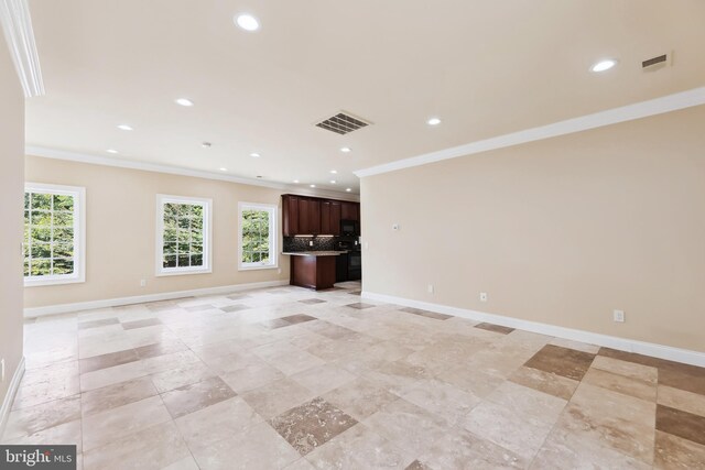 unfurnished living room featuring crown molding