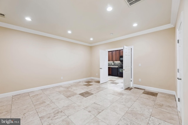 spare room featuring ornamental molding