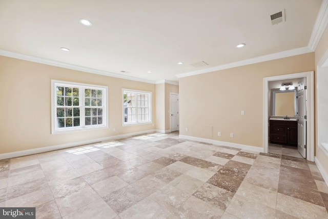 unfurnished room featuring crown molding and sink